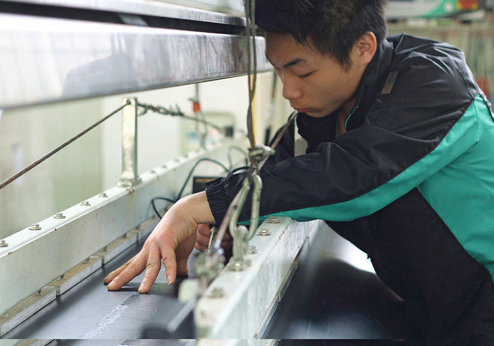 IMG_9770-carousel.jpg man servicing conveyor machinery